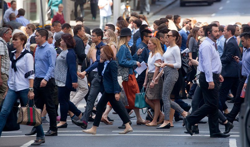 View of rushing pedestrians crossing street