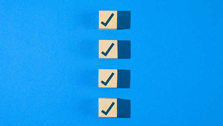 5 wooden cubes ticks blue background