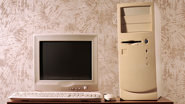 Computer with keyboard and mouse on wooden table