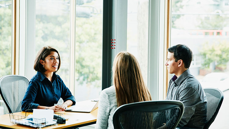 Three people office meeting