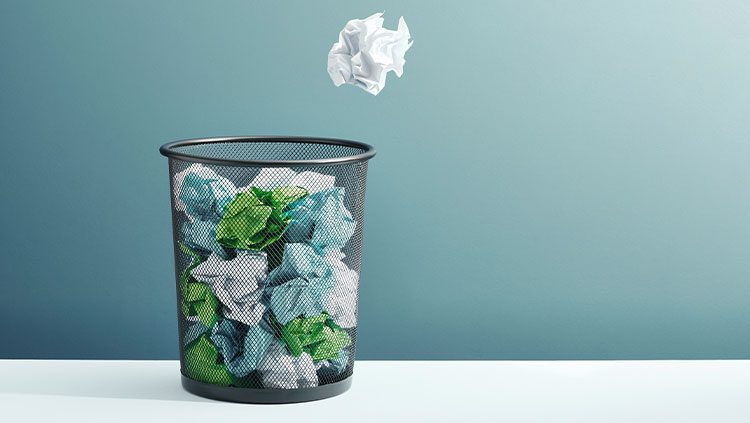 Trash can with crumpled paper