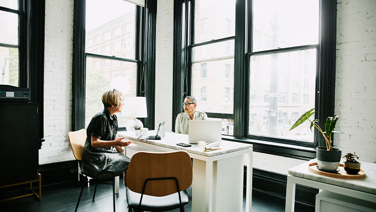 Two people meeting office