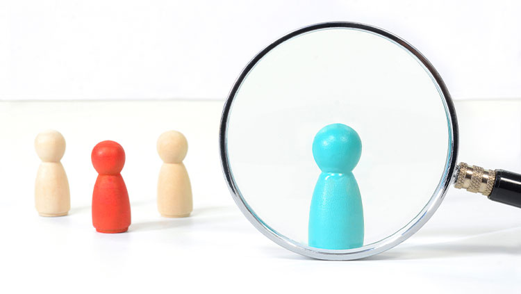 Wooden people magnifying glass