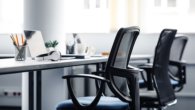 Empty office desks chairs