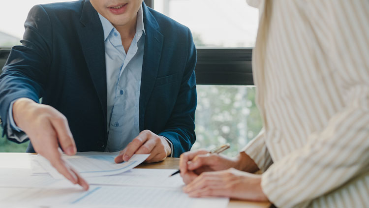 Two people meeting discussing documents