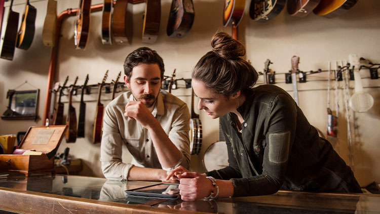 Two people talking guitar shop