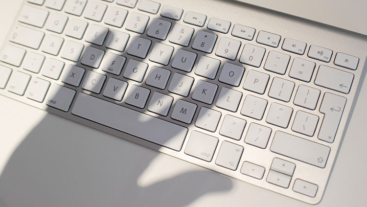 Hand shadow over keyboard