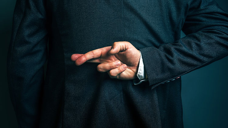 Business person crossing fingers behind back