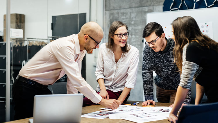 Group workers talking over desk