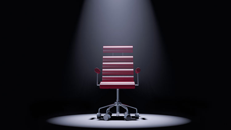 Office chair in spotlight dark background