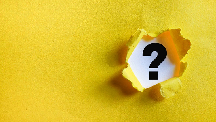 Yellow paper torn open to reveal a white surface marked with a black question mark.