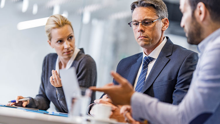 Business meeting three people serious