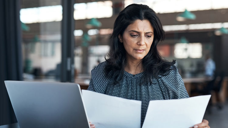Business person looking at documents serious
