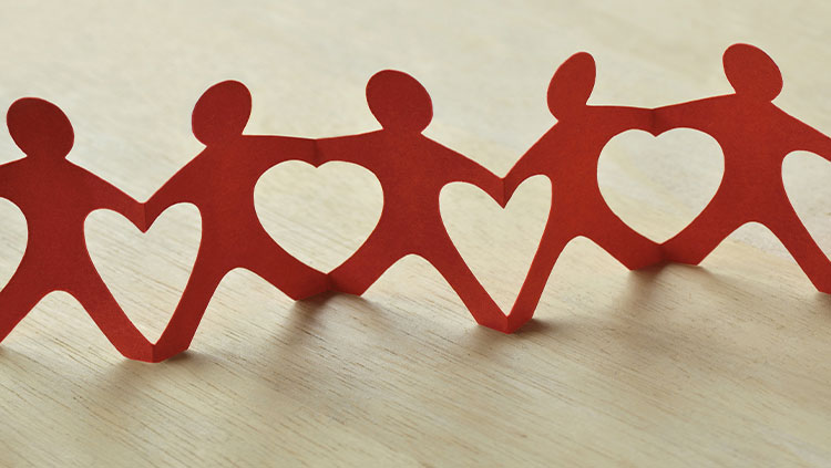 Paper people cut out with love hearts