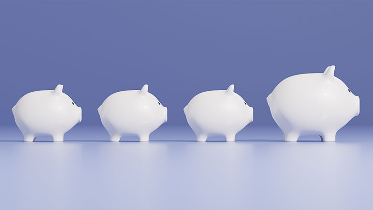 White piggy banks on purple background with one bigger