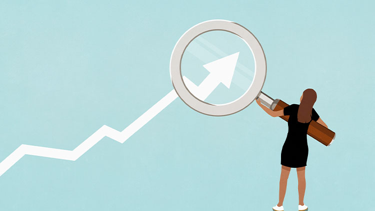 Woman holding magnifying glass over ascending graph arrow on blue background