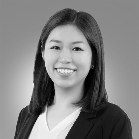 Professional headshot portrait of a person wearing business attire against a plain background